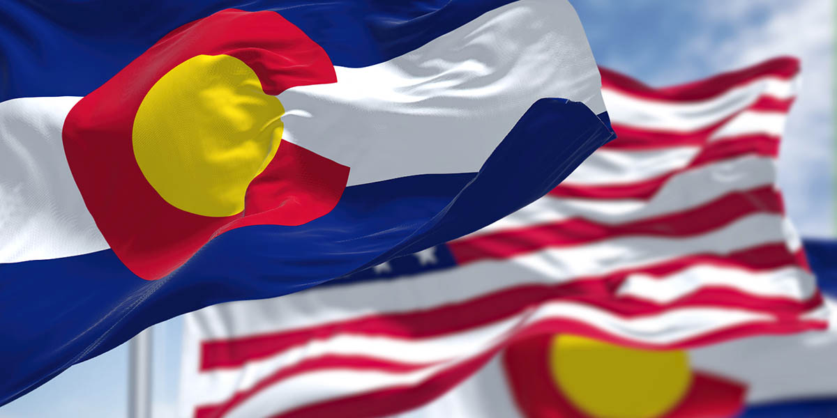 Colorado state flags waving along with the national flag of the United States of America