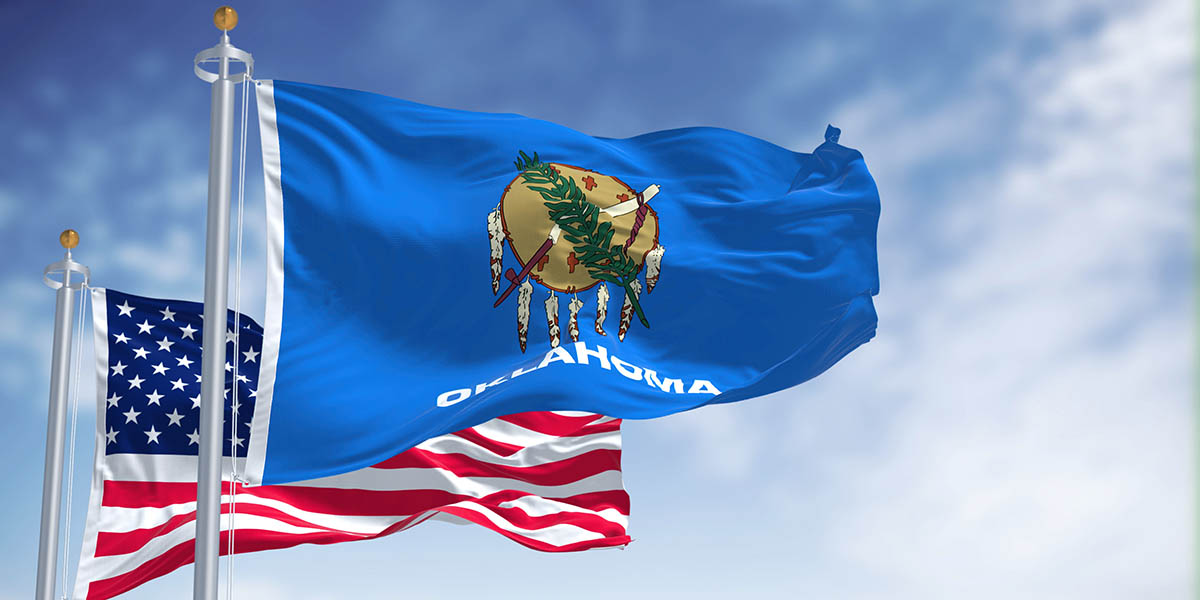The Oklahoma state flag waving along with the national flag of the United States of America