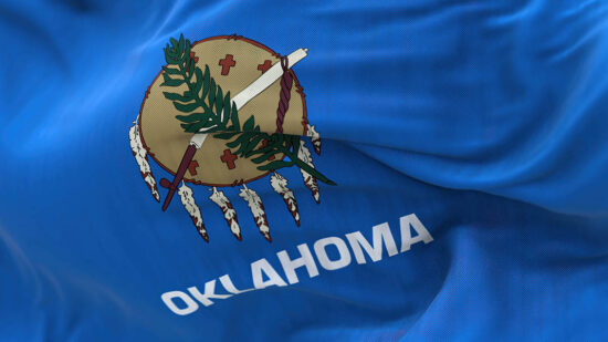 Close up view of the Oklahoma state flag waving.