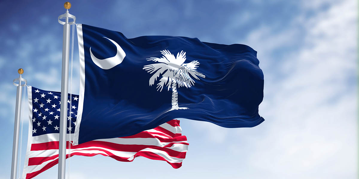 The South Carolina state flag waving along with the national flag of the United States of America