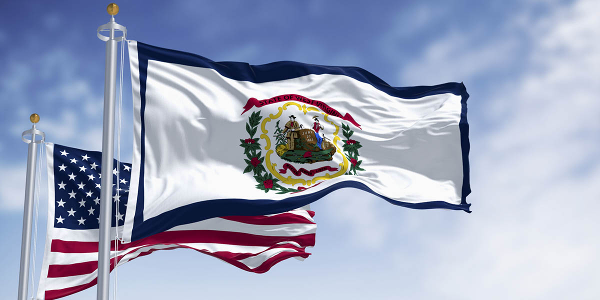 Close-up of West Virginia state flag waving in with the american flag